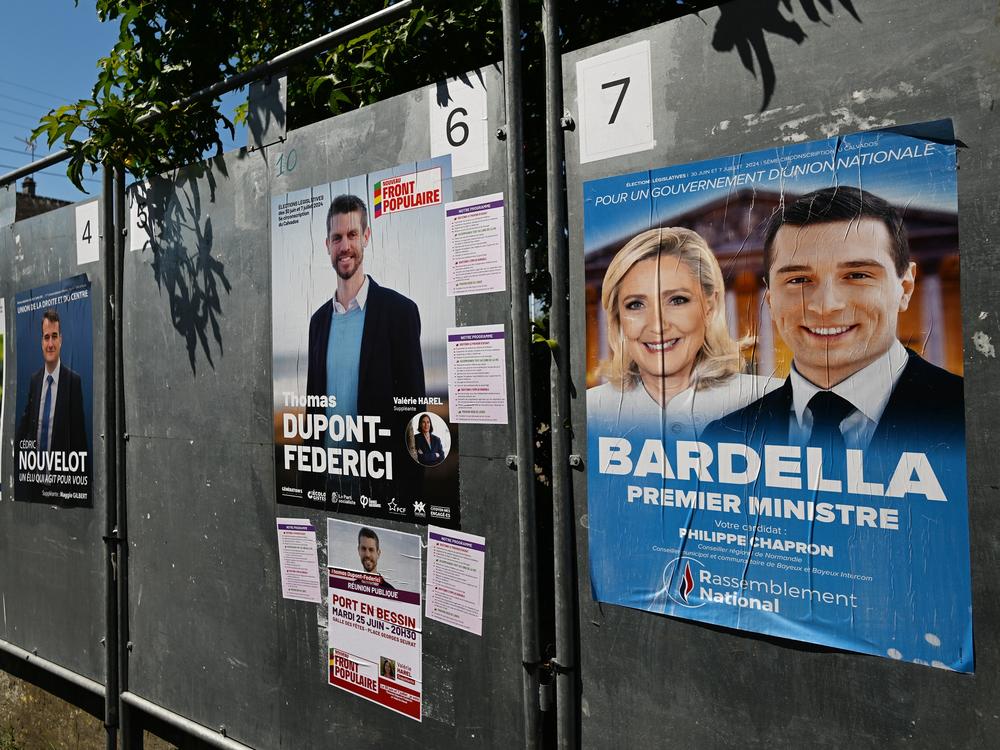 Posters with images or names of local candidates for the first round of the 2024 French legislative elections displayed in front of the local town hall in Port-en-Bessin-Huppain, Normandy, France, on June 25. France will hold an early legislative election in two rounds, on June 30 and July 7.