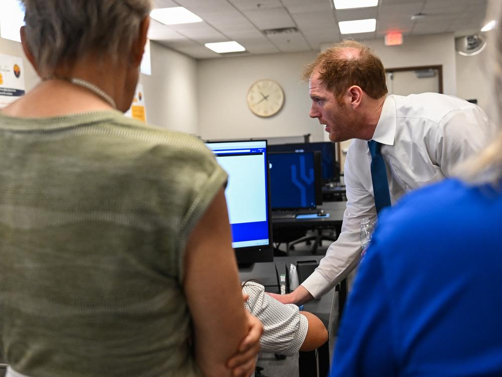 Maricopa County Recorder Stephen Richer demonstrates signature verification for early voting ballots to a tour group of Republican women on June 3 in Phoenix. Richer himself faces primary challengers this month.