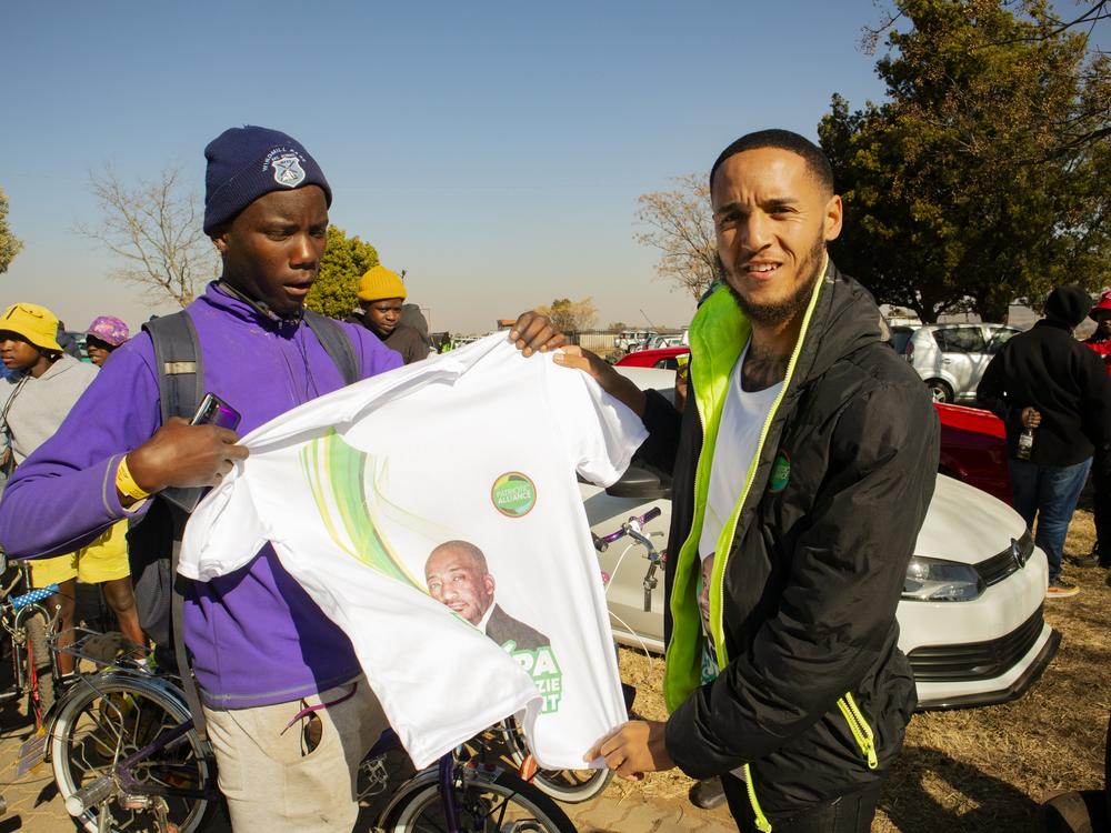 Elon Rayners hands out T-shirts for the Patriotic Alliance party, featuring the face of new South African Sports Minister Gayton McKenzie, at Wheelz N Smoke arena.