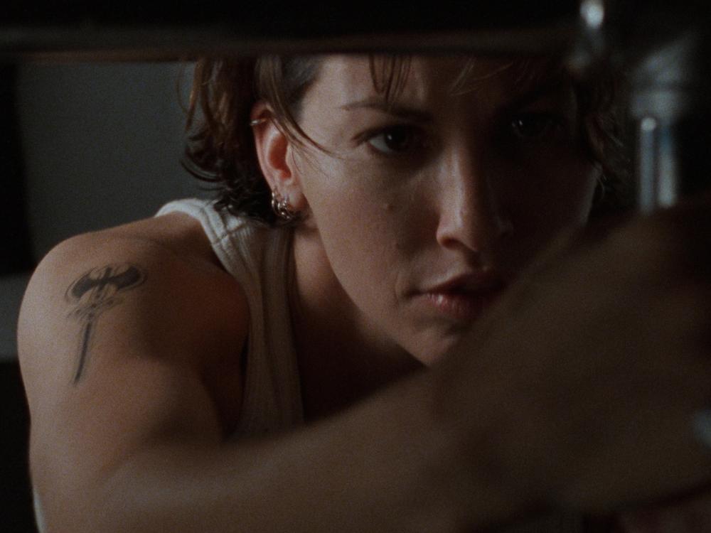 Gina Gershon as Corky in <em>Bound</em>. The Wachowskis have said that casting Corky and her love interest Violet was challenging, and some studios even advised that Corky's character be re-written as a man. 
