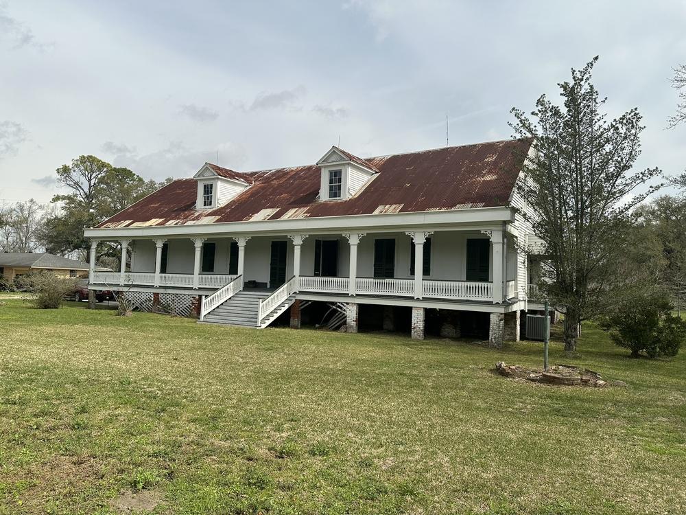 The Woodland Plantation House sits near the banks of the Mississippi River in LaPlace, La. The raised creole-style building with a rusty tin roof and wide front porch has Black owners for the first time. The site is historically significant because it's where one of the largest slave revolts in U.S. history began.