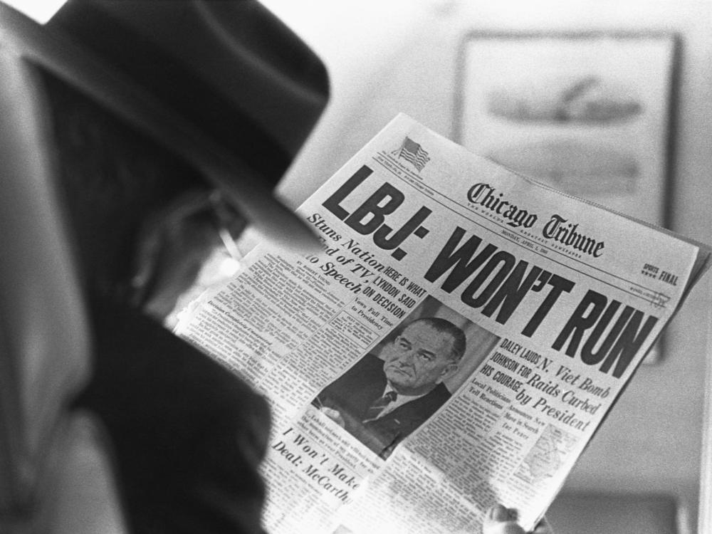 A man reads the news in the April 1, 1968 <em>Chicago Tribune</em> announcing President Lyndon B. Johnson's decision not to run for reelection. 
