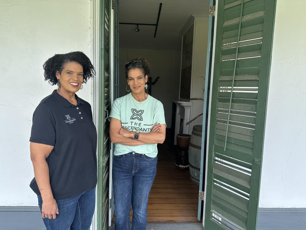Twin sisters Jo (left) and Joy Banner stand at the front door of the Woodland Plantation House. “We have still a lot of work to do, but I think for the home to be from 1793, it looks rather good,” Jo says.