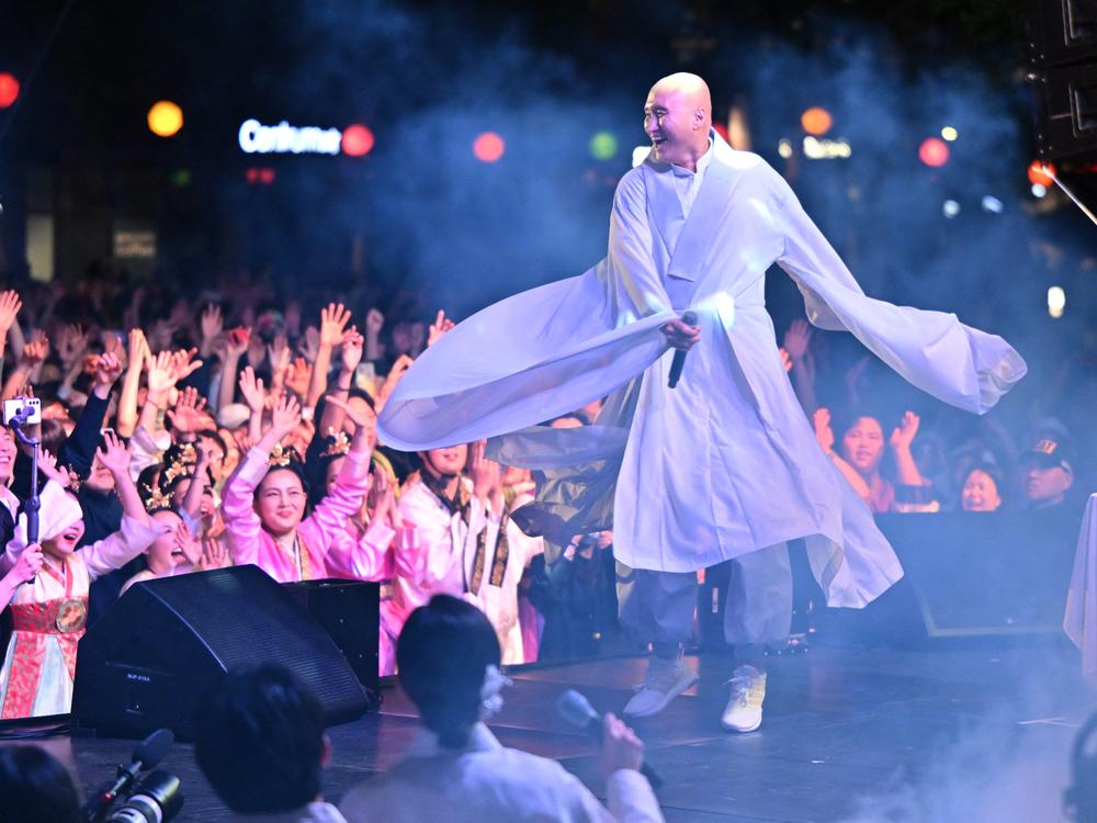 South Korean comedian Yoon Seong-ho, known as NewJeansNim, wearing monk's robes and performing during an electronic dance music party event for the annual Lotus Lantern Festival to celebrate the Buddha's birthday in Seoul, on May 12.