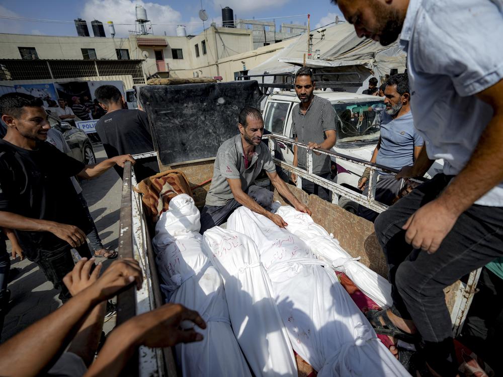 Palestinians gather near the bodies of their relatives killed in the Israeli bombardment of the Gaza Strip, at a hospital morgue in Deir al-Balah, on Saturday.
