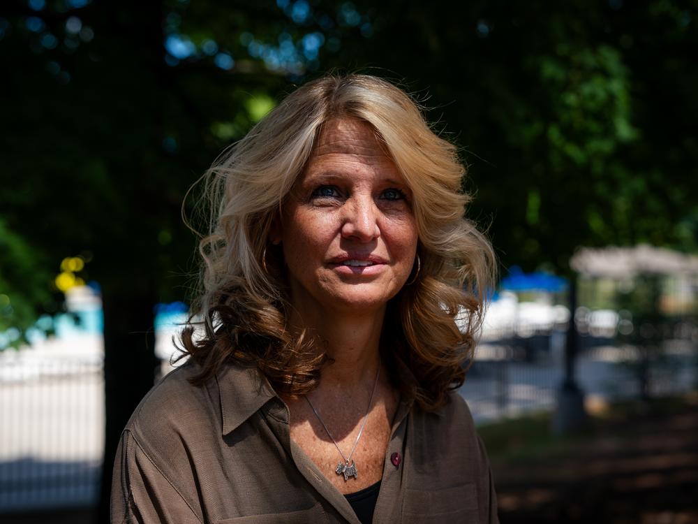 Kerry Webster, a voter who says she voted for Trump in 2020 but isn't sure she will again in 2024, poses for a photo at the Wills Park Pool in Alpharetta, Ga.  