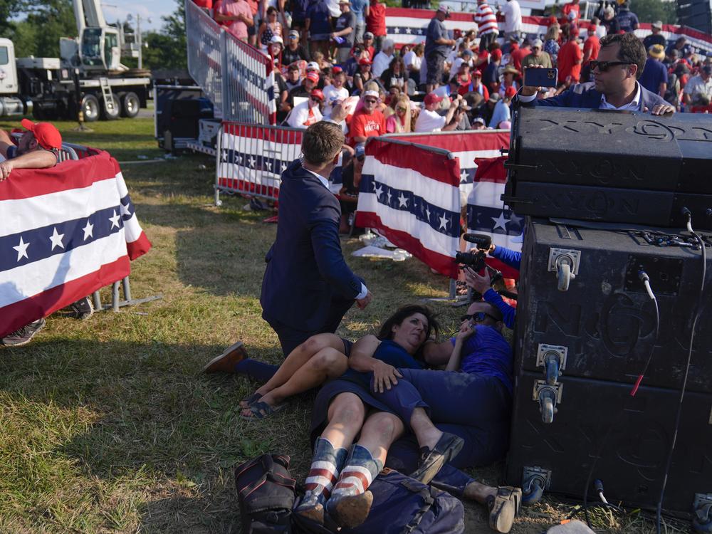 People react during a campaign rally with Republican presidential candidate former President Trump.