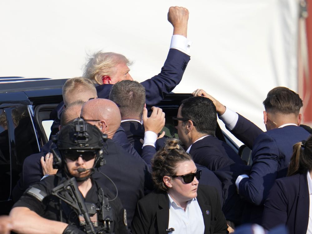 Republican presidential candidate former President Trump is helped off the stage.