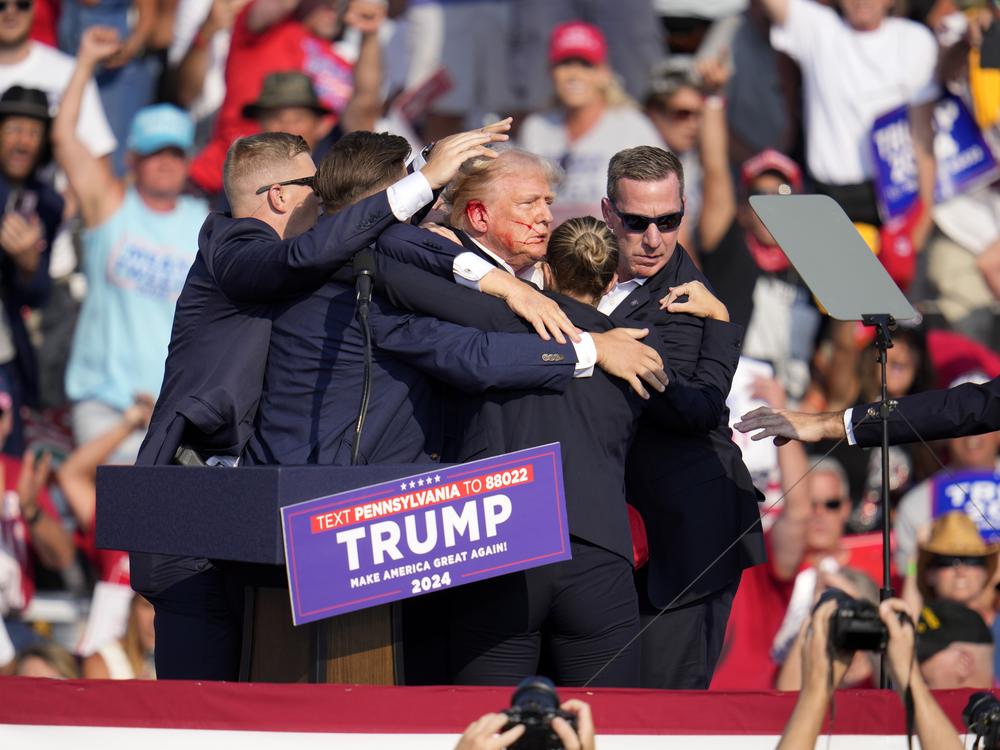 Republican presidential candidate former President Trump is helped off the stage.