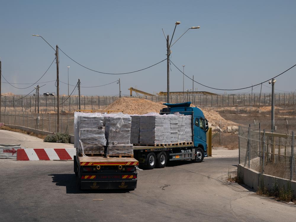 A truck loaded with food on the Israeli side of the border crossing heads back into Gaza. However, the food is sitting for days or weeks before it can be distributed. The U.N. and aid groups say they face a host of problems that include a shortage of trucks and fuel due to the war, as well as criminal gangs that are looting the supplies. 