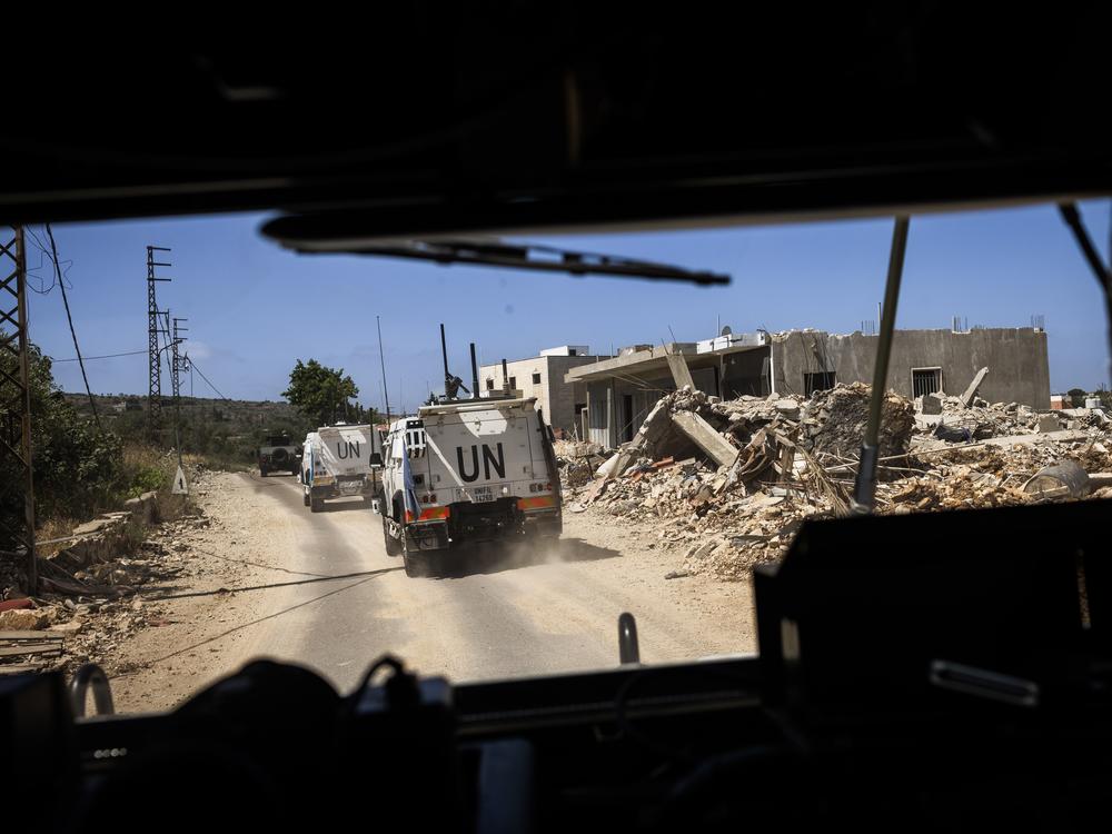 The view from a UNIFIL armored vehicle shows destruction from the conflict in Lebanon.