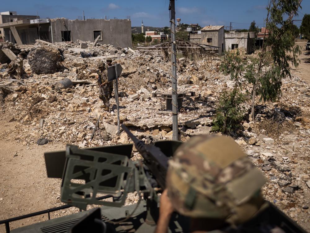Members of the Lebanese army and the Italian contingent of the UNIFIL peacekeeping force inspect a house destroyed by an Israeli attack during a patrol in Yarine on June 10, 2024.