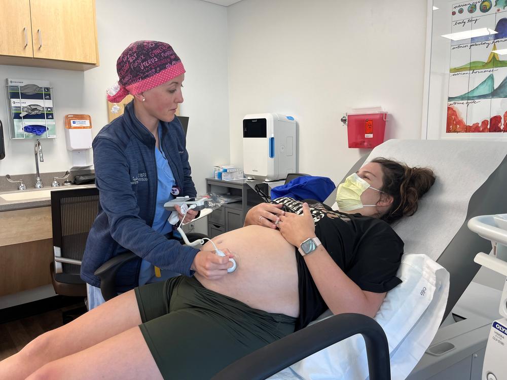 Obstetrician-gynecologist Taylar Swartz uses an ultrasound scanner to check the health of Addie Comegys' baby on May 30. Comegys, who is due in late August, had traveled 45 minutes for her prenatal appointment at Mahaska Health in Oskaloosa, one of a few rural hospitals in Iowa still offering labor and delivery services.