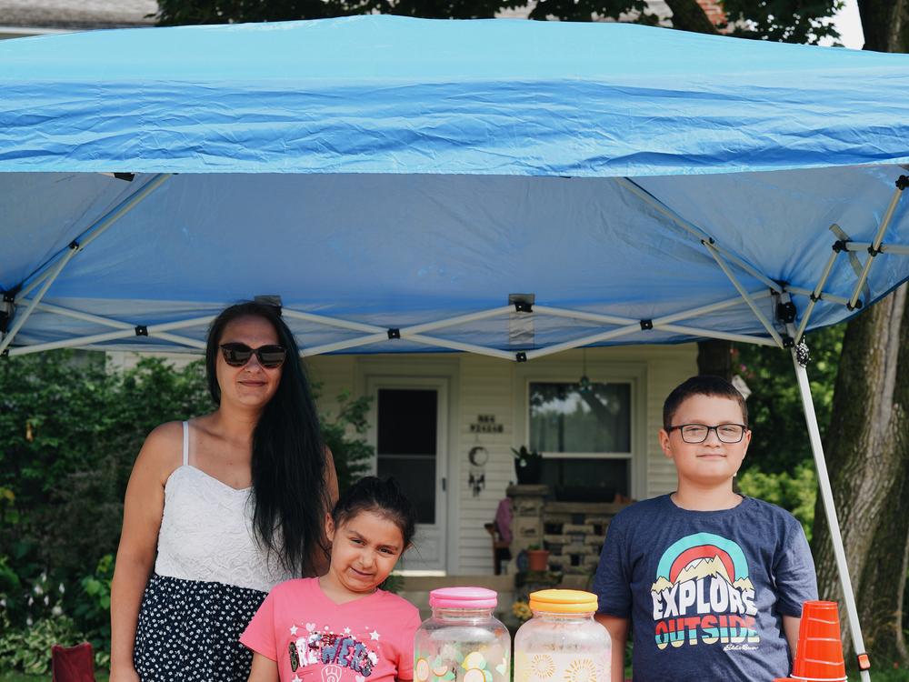 Samantha Garcia has set up a lemonade stand with her two kids, Winnie and Rafael, along the parade route for the past three years.