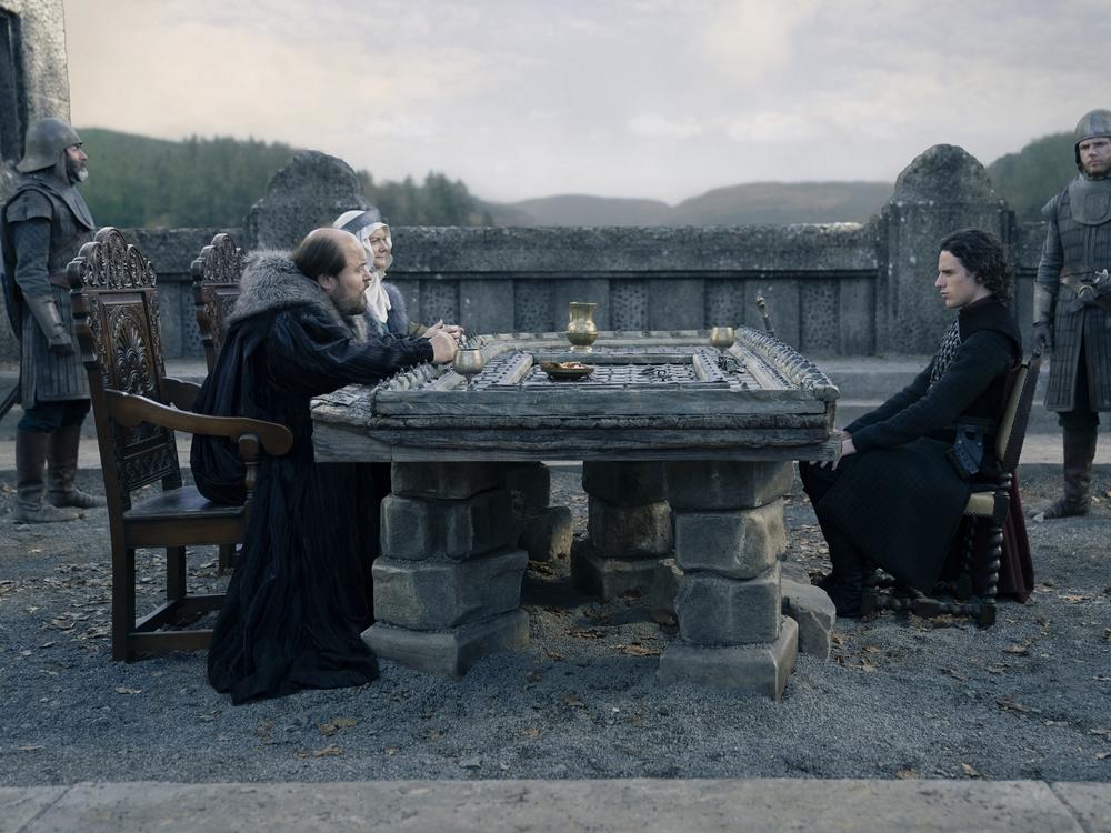 The Freys (Kenneth Collard and Sarah Woodward) and Jacaerys (Harry Collett) table their discussion. 