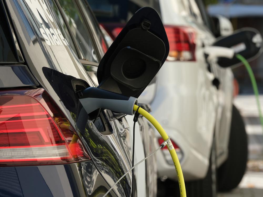  An electric car and a plug-in hybrid car charge at a public charging station on October 12, 2019 in Berlin, Germany.