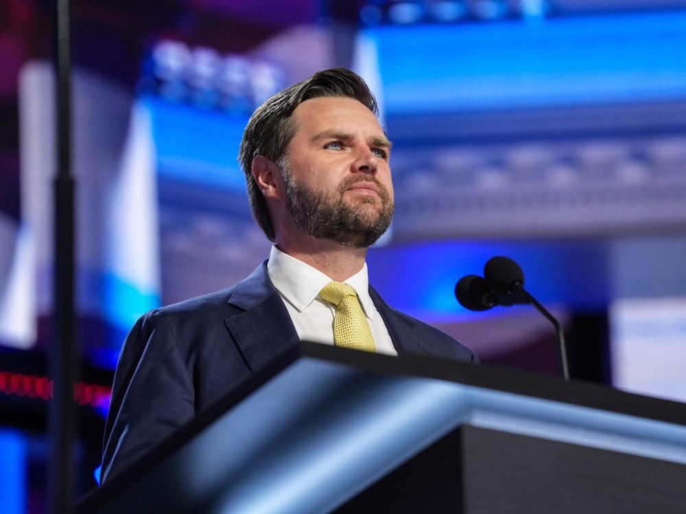 J.D. Vance, Trump's vice presidential running mate, stands at a podium during a walkthrough for the 2024 Republican National Convention in Milwaukee.