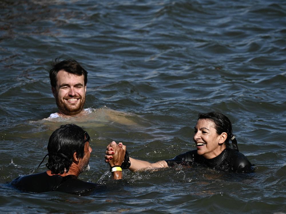 Paris Mayor Anne Hidalgo swims in the Seine, in Paris on July 17, to demonstrate that the river is clean enough to host the outdoor swimming events at the Paris Olympics later this month.