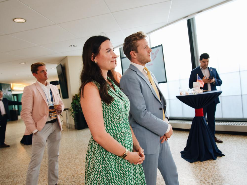 Danielle Butcher Franz and Chris Barnard listen as guests speak at the Conservative Climate Reception held at Mitchell Park Domes in Milwaukee, Wisconsin on the second day of the Republican National Convention. 