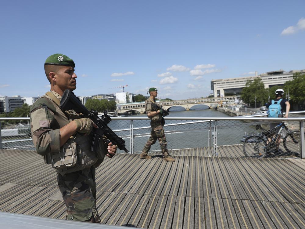 Soldiers patrol on a footbridge over the Seine River on Wednesday in Paris.