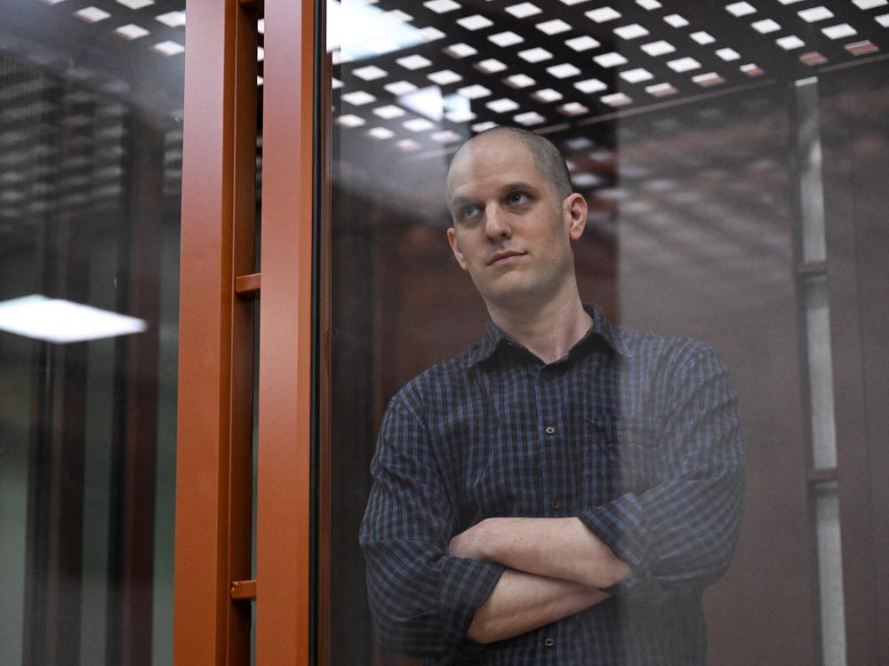 Evan Gershkovich, accused of espionage, looks out from inside a glass defendants' cage prior to a hearing in Yekaterinburg's Sverdlovsk Regional Court on June 26.