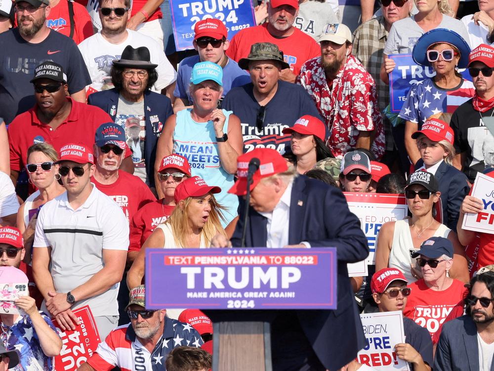 Trump starts ducking downward after gunfire rings out during the campaign rally in Butler.
