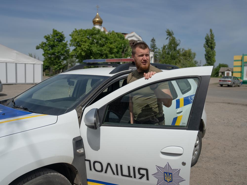 Oleksii Kharkivskyi, the chief of the patrol police of Vovchansk, in his police car in an undisclosed location in Kharkiv Oblast, Ukraine, on May 26.
