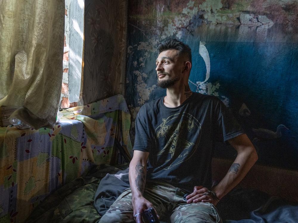 Nur, an artillery unit commander for the 57th brigade, poses for a portrait in a command center in the Kharkiv region on May 29.