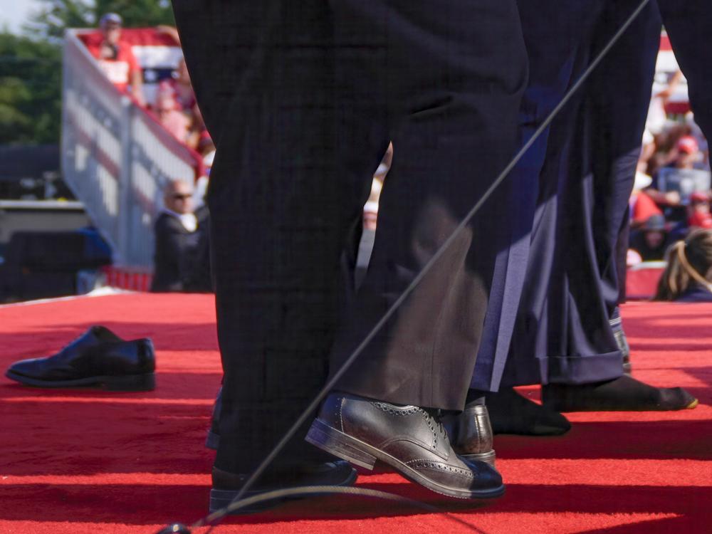 One of Trump's feet has lost its shoe, which is seen at left on the stage where he was speaking when a gunman attempted to assassinate him.