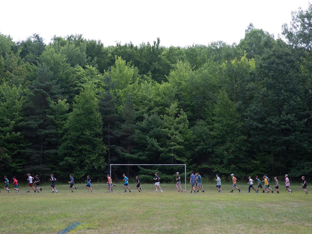 Older boys run laps on the <em>sportova ploshta</em>, or 