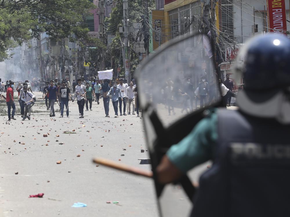 Students clash with riot police during a protest against a quota system for government jobs, in Dhaka, Bangladesh, Thursday, July 18, 2024.