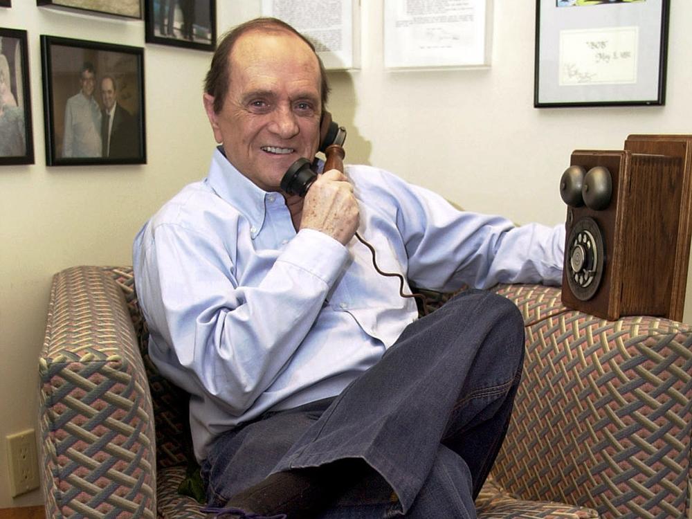 Comedian Bob Newhart pretends to speak on an antique telephone at his home in the Bel Air Estates community of Los Angeles, June 25, 2003. 
