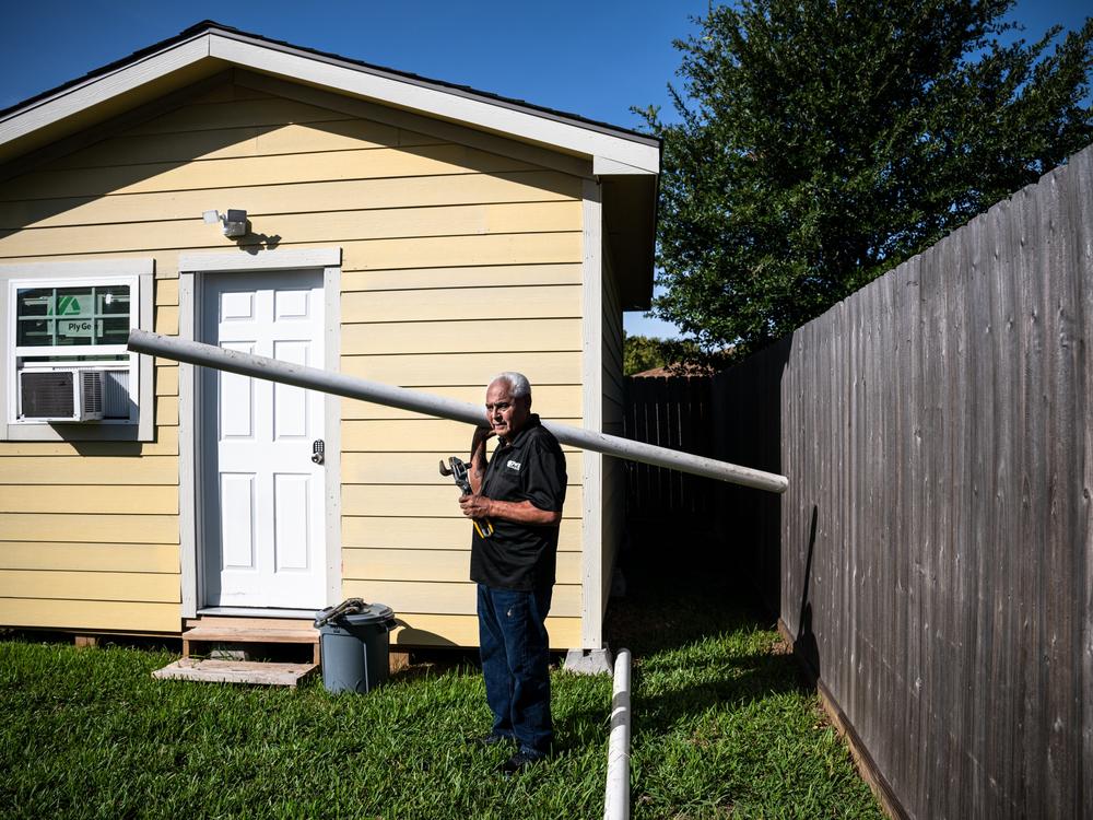 Larry Martin, 68, holds some of his late son’s tools and a pipe from the last plumbing job they worked together. 