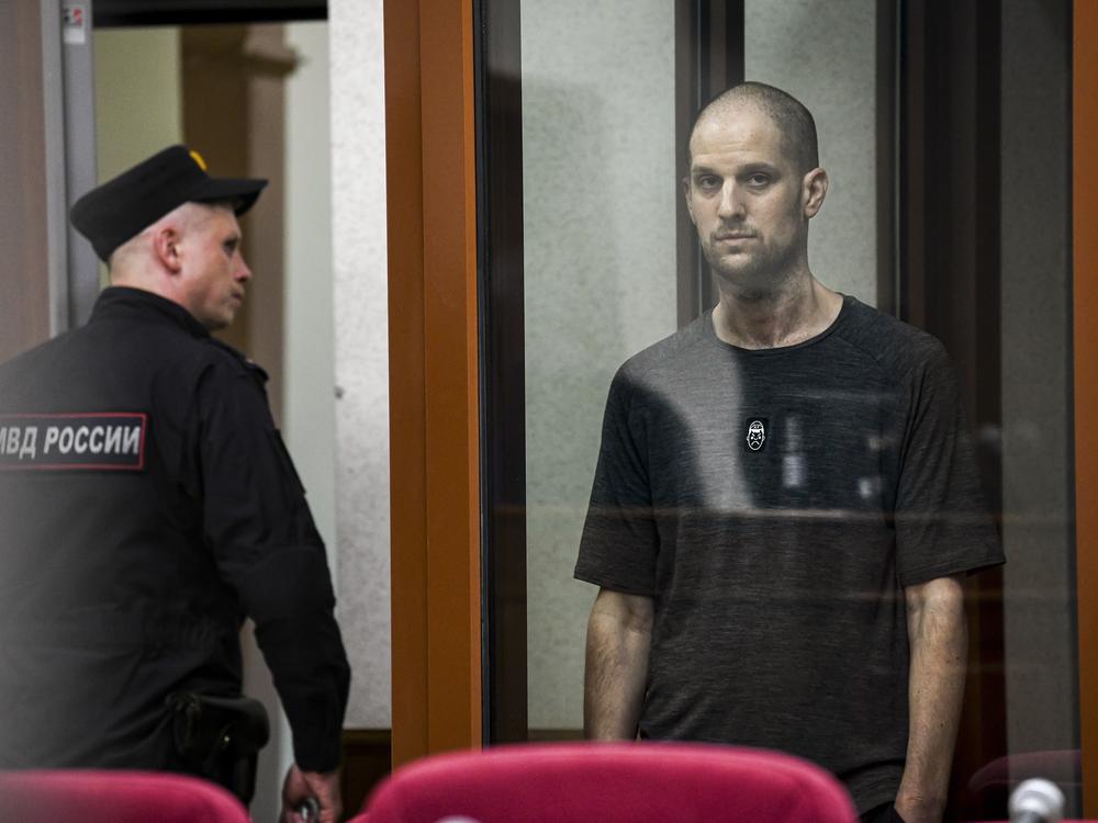 <em>Wall Street Journal</em> reporter Evan Gershkovich stands in a glass cage of a Russian courtroom on  July 19. A Russian court convicted Gershkovich on espionage charges that his employer and the U.S. have rejected as fabricated. He was sentenced to 16 years in prison after a secretive and rapid trial. 