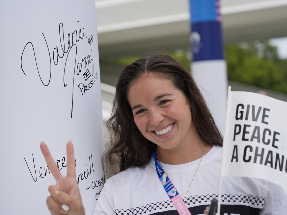 Palestinian swimming athlete Valerie Rose Tarazi flashes the V sign during the inauguration of the Olympic Truce Wall in the Olympic Village at the 2024 Summer Olympics on Monday in Paris.