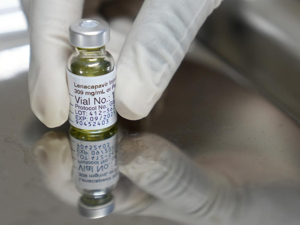 A pharmacist holds a vial of lenacapavir, the HIV prevention injectable drug that was shown to be 100% effective in newly published clinical trial data.