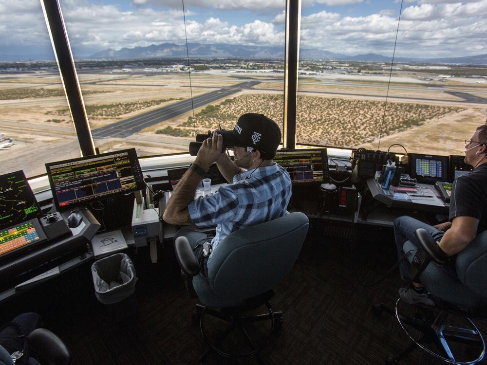 Air traffic controllers watch for traffic from the control tower at the Tucson International Airport on Sept. 23, 2016 in Tucson, Ariz.
