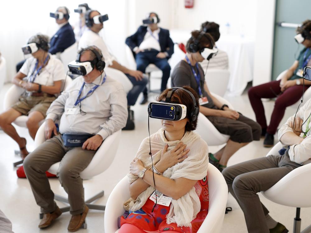 Visitors watch <em>Jesus VR: The Story of Christ</em> during the 73rd Venice Film Festival in 2016.