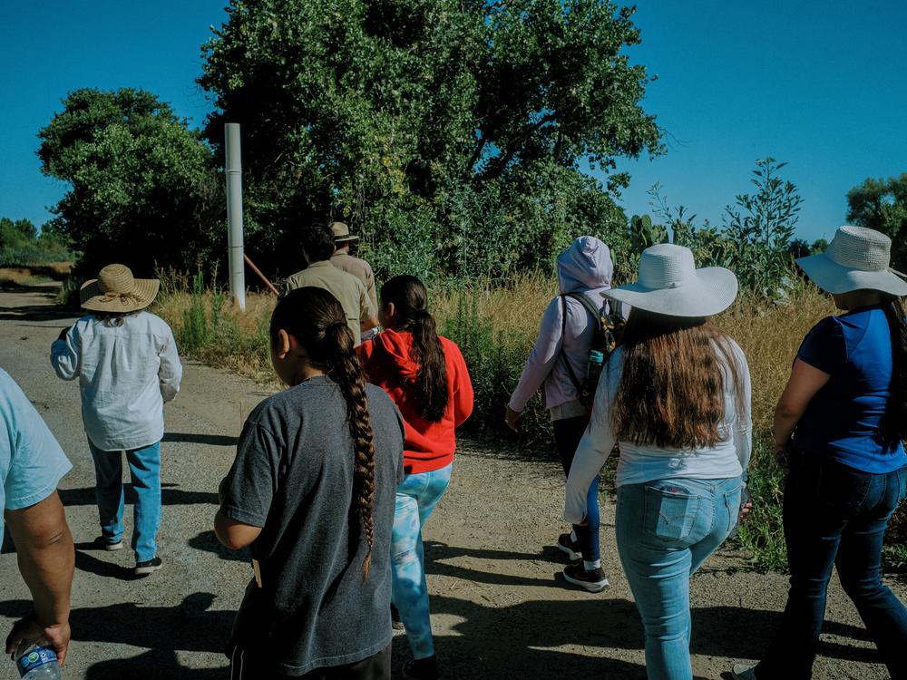Eduardo Gonzalez and Julian Morin lead Grayson community members on a tour of Dos Rios in late June.