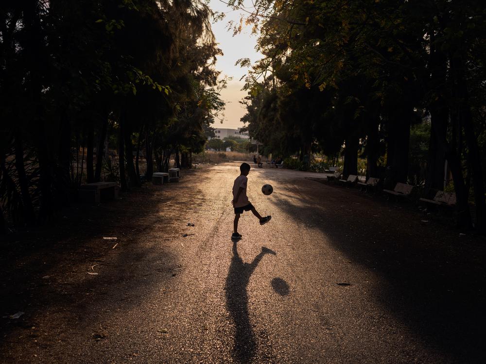 A child who's been displaced by the clashes between Hezbollah and the Israeli army plays outside a school converted into a temporary shelter for internally displaced people.