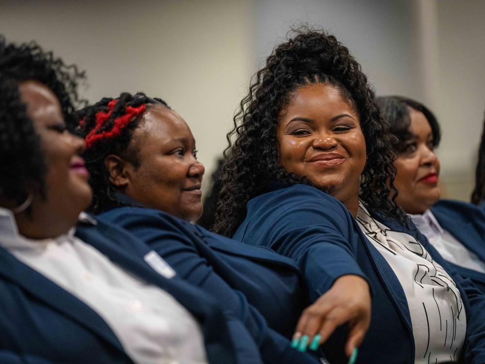 Bristeria Clark (center) at the graduation ceremony for Morehouse School of Medicine's first class of rural doulas, called perinatal patient navigators. Clark, who's also a nurse and county employee, wants other women to have more support than she did while navigating pregnancy, childbirth and postpartum care.