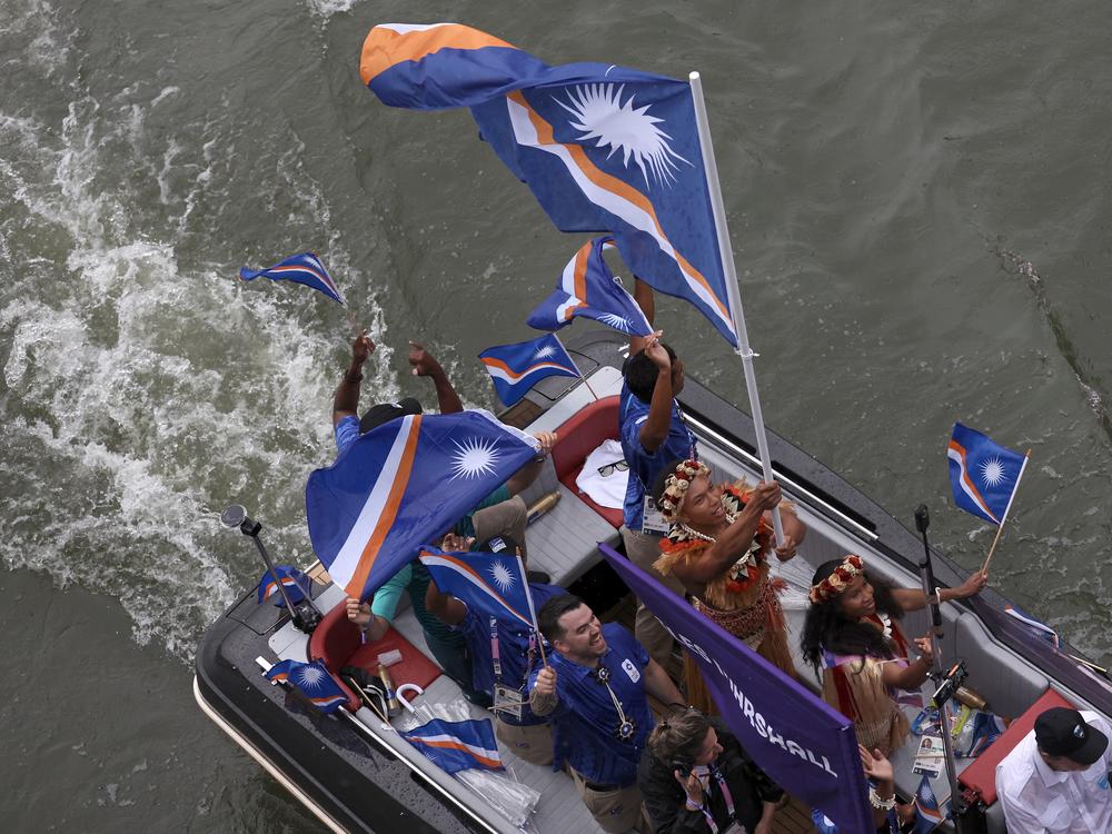 Team Marshall Islands are seen on a boat on the River Seine during the opening ceremony.