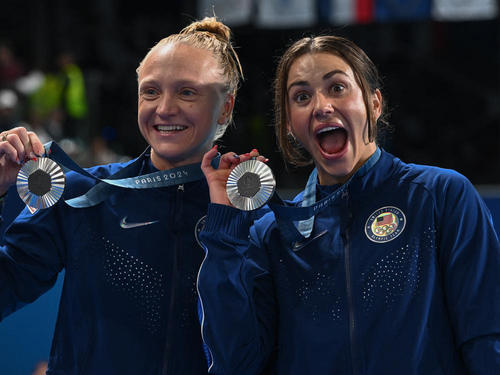 The United States won its first medals at the Paris Olympic Games when Kassidy Cook and Sarah Bacon took silver in the synchronized 3m springboard final on Saturday. Cook (right) and Bacon pose after the competition at the Aquatics Center in Saint-Denis, north of Paris.