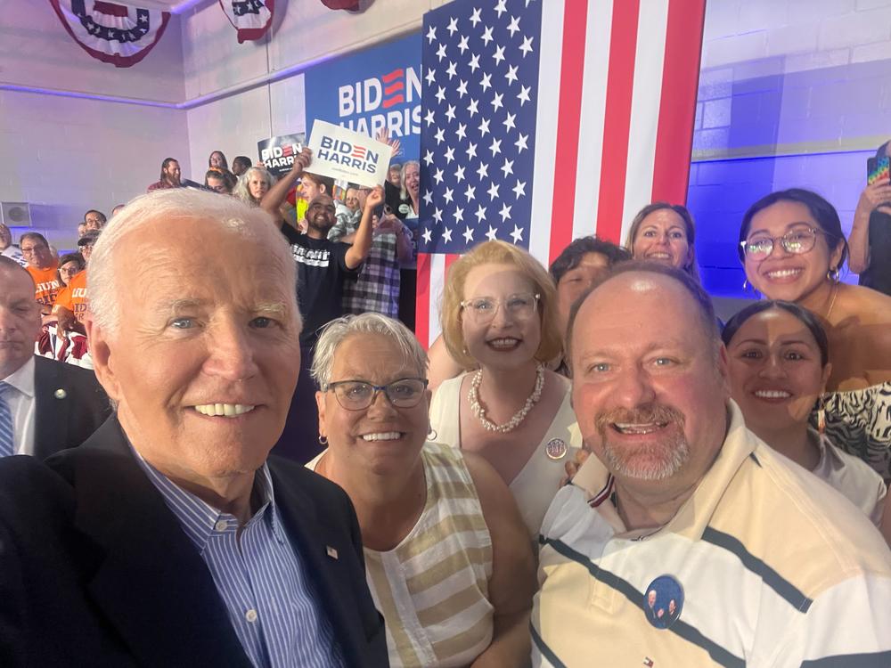 President Biden takes a selfie with Christine Sinicki, center, and other supporters at a rally in Madison, Wis. on July 5.