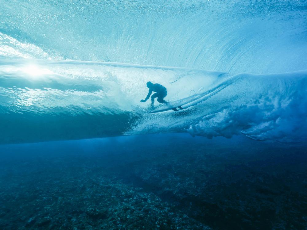 France's Joan Duru rides in a barrel in Teahupo'o, skimming feet above the ocean floor.
