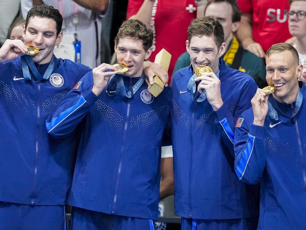 Team USA's men's swimming team stands on the podium after winning gold in the men's 400-meter freestyle relay final at the Paris Olympics on Saturday.