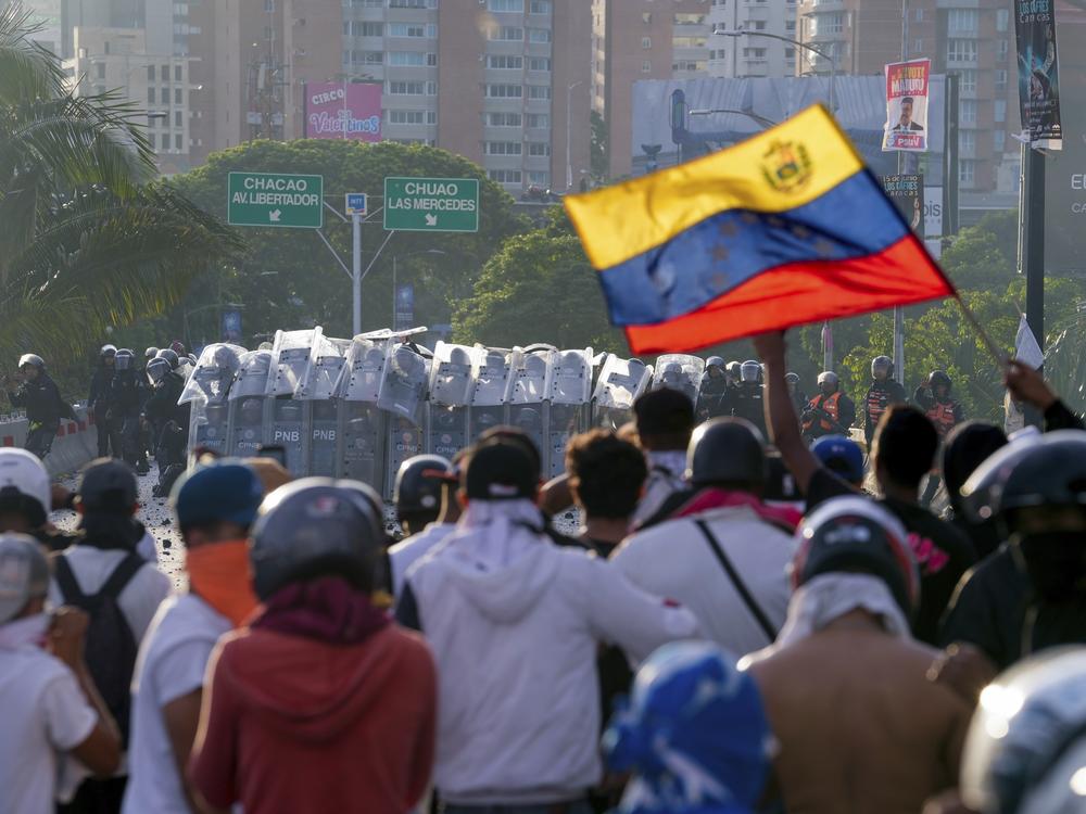 Police block protesters during demonstrations against the official election results declaring President Nicolás Maduro's reelection, the day after the vote at a highway in Caracas, Venezuela, Monday.