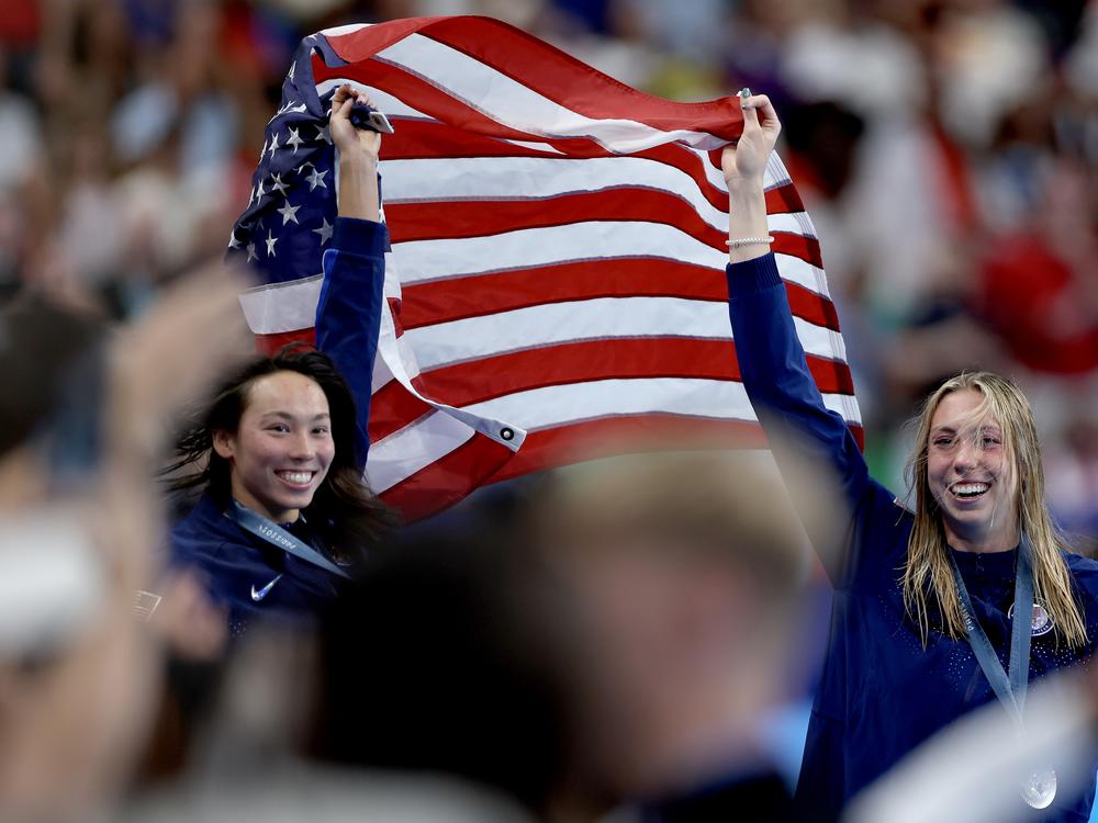 Gold medalist Torri Huske and silver medalist Gretchen Walsh of the United States celebrate after their 1-2 finish in the women's 100-meter butterfly final at the 2024 Olympic Games in Paris. 
