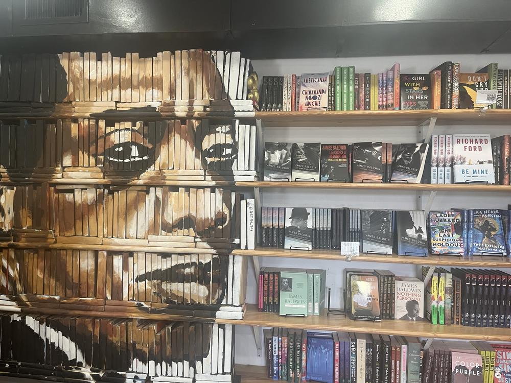  James Baldwin's face is painted upon a decorative shelf of books in the Baldwin & CO bookstore in New Orleans