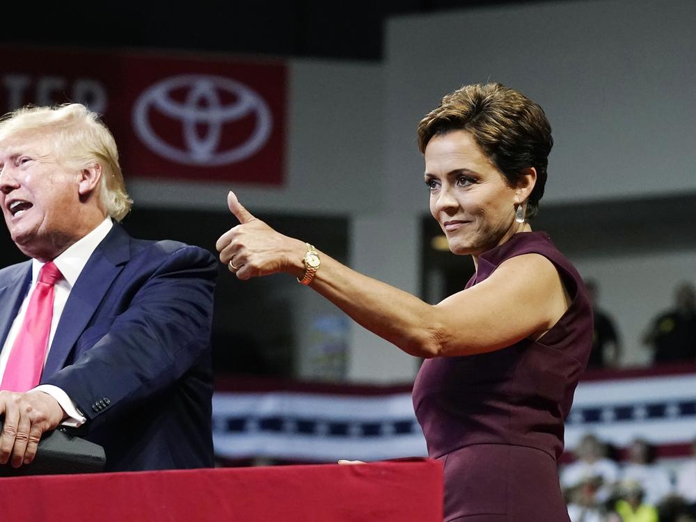 Arizona Republican candidate for governor Kari Lake gives a thumbs up to the crowd as former President Donald Trump speaks at a Save America rally on Friday, July 22, 2022, in Prescott, Ariz. 